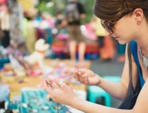 Photo of a woman holding jewelry.