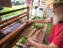Man playing his instrument at the Mohican Traditions Festival