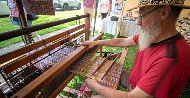 Man playing his instrument at the Mohican Traditions Festival